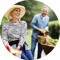 Retired couple outside gardening.