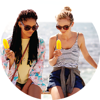 Two young women on vacation at the beach.